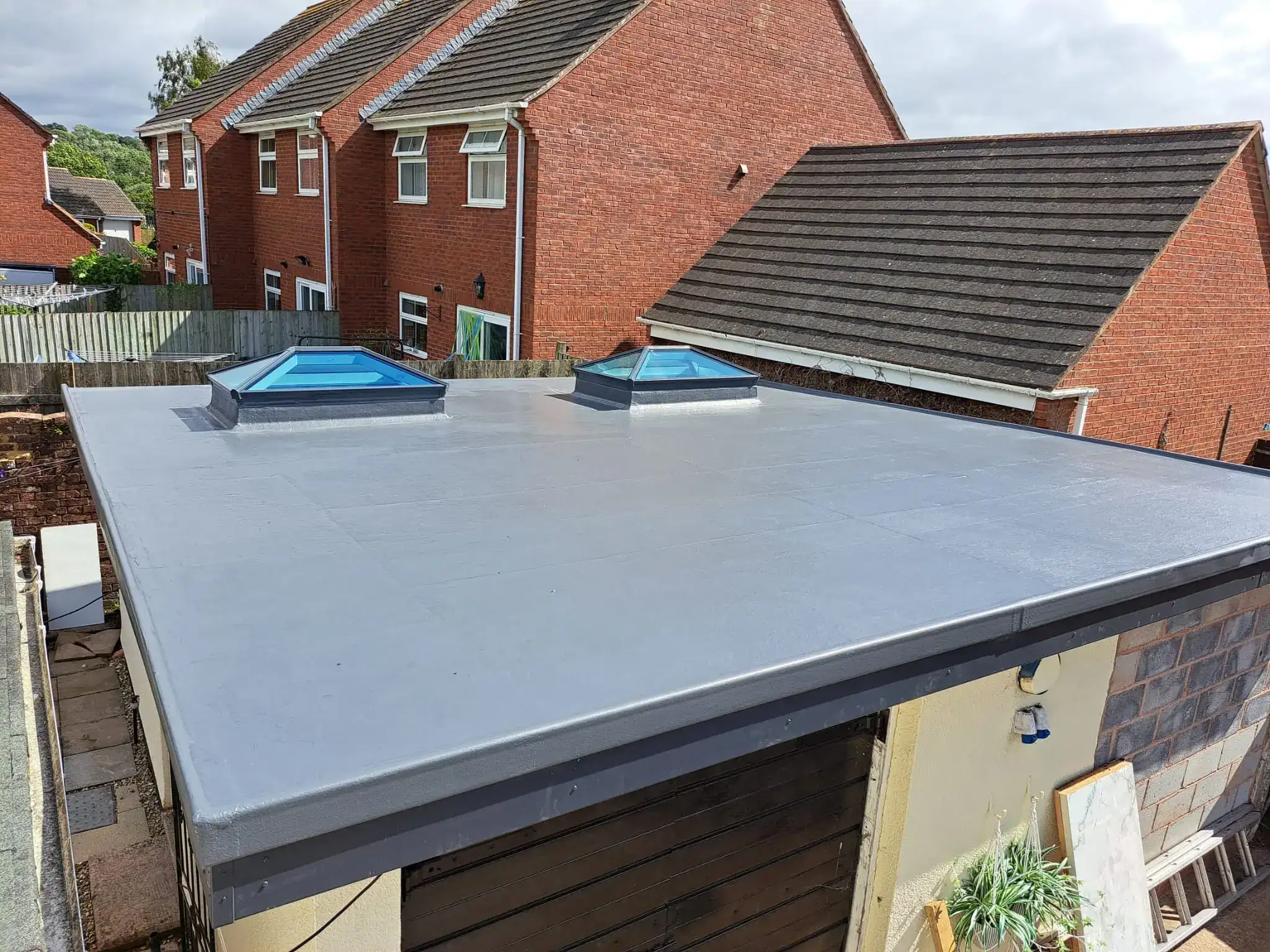 New flat roof with two roof lanterns on a single-storey extension